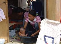 Having just moved into the wooden hut from the tents, its first bath time for this youngster